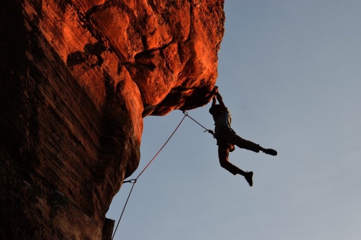 Bucket list: Climber hangs from a ledge
